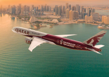 Qatar Airways Airplane Flying over a city
