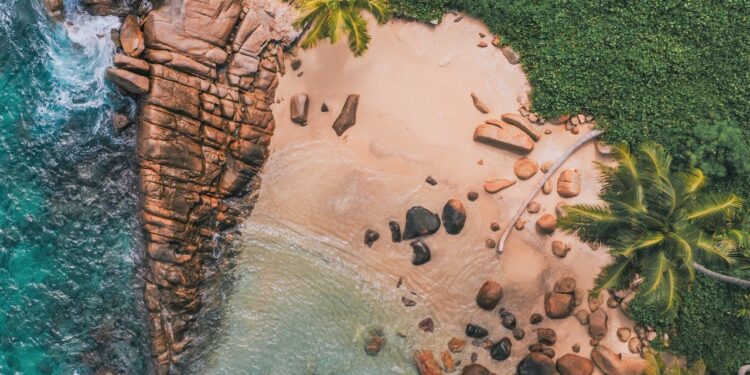 Seychelles drone shot of beach cliffs