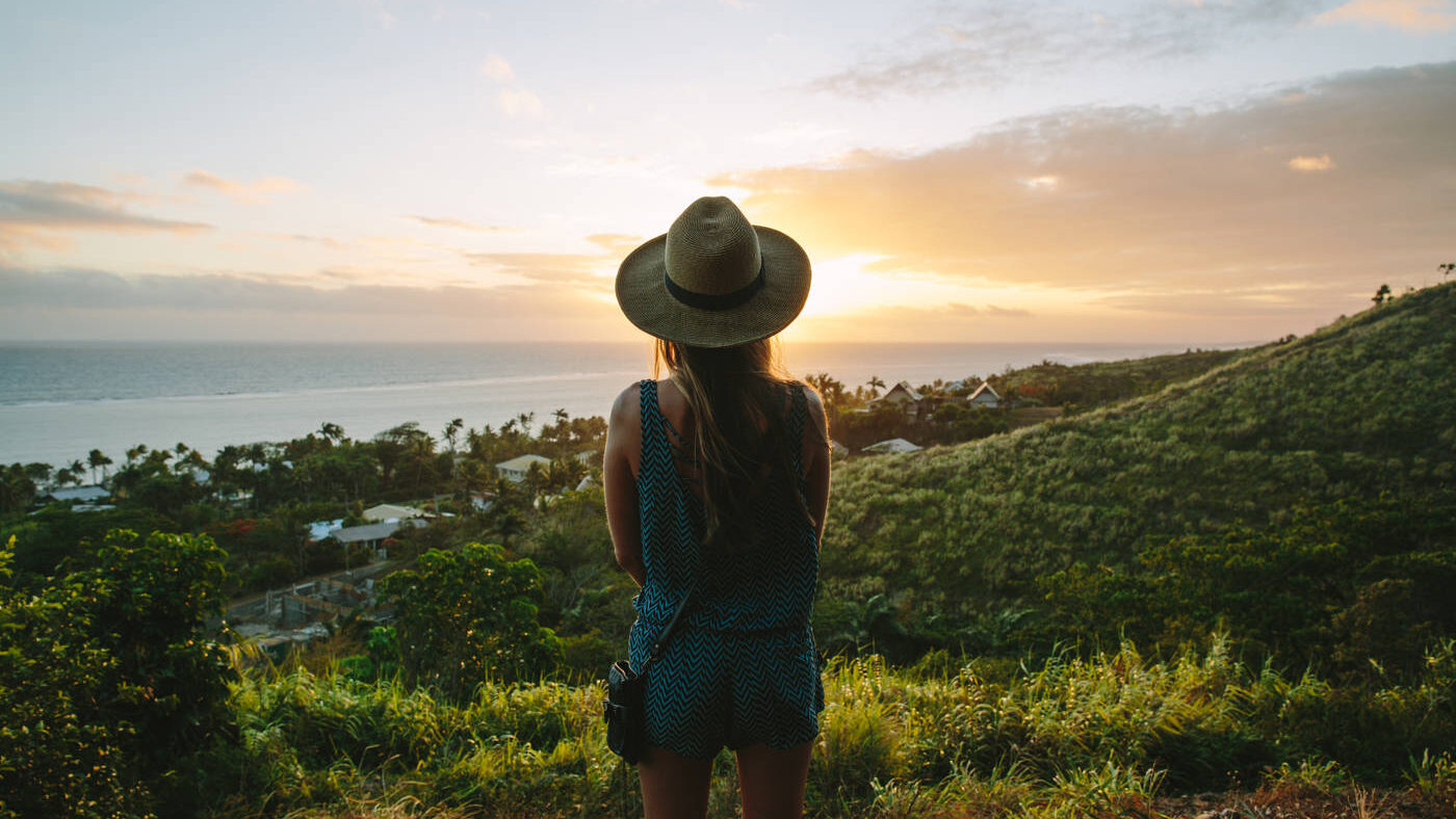 A person standing on a hill watching a sunset view in Fiji