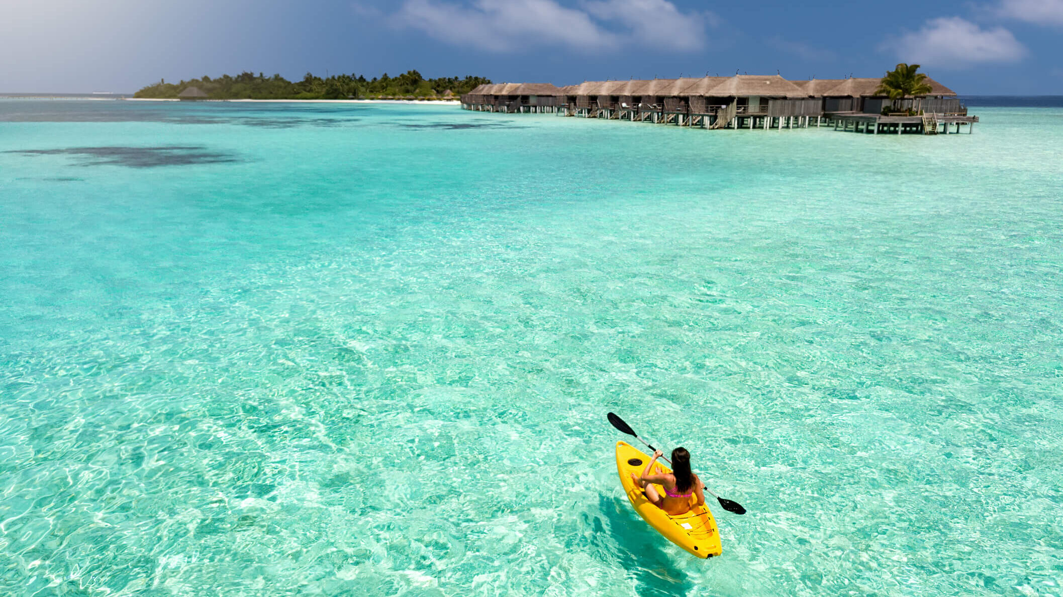 Woman kayaking in Maldives lagoon